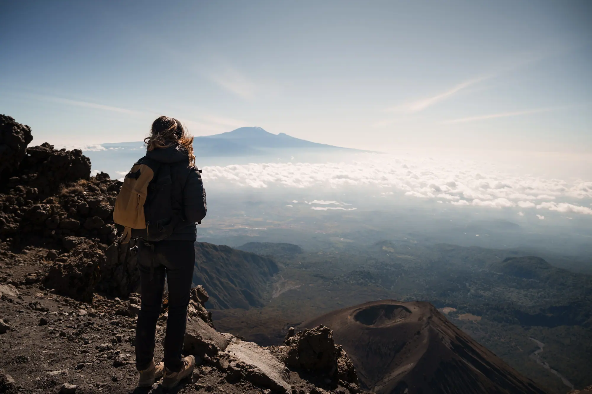 Hiker contemplating mount kilimanjaro from mount