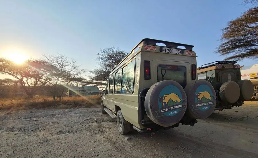 Active Wonders Safaris Land Cruiser on the plains at sunset